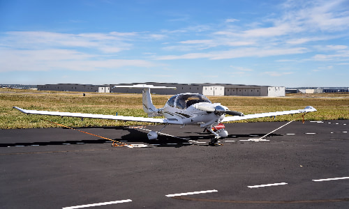 airplane tied on tarmac with rope